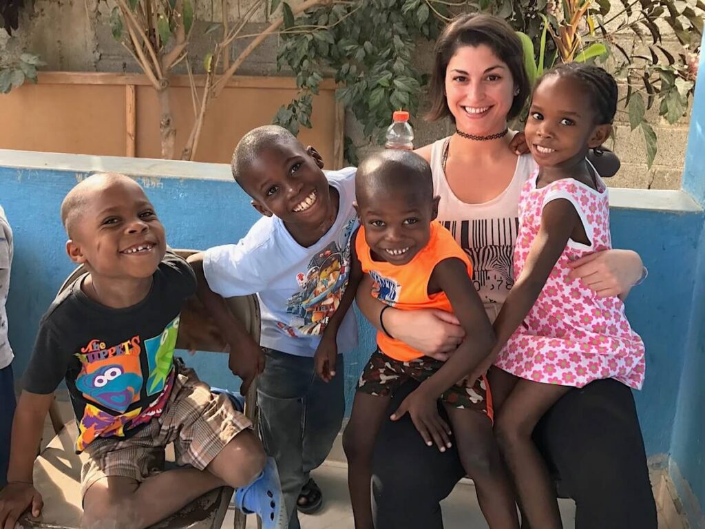 Haiti Orphanage Visit with four smiling children and one adult