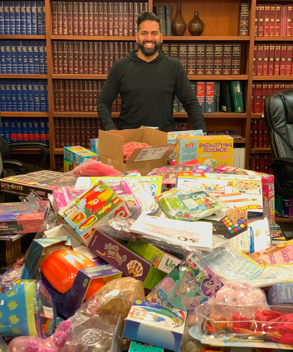 A pile of toys in front of a man in a law office 